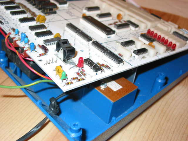 The top side of the a Heathkit ET-3400 SBC with the normally hidden part of the circuit board exposed.  There is a 14-pin DIP IC that has 3 pins bent up and not placed in the socket.