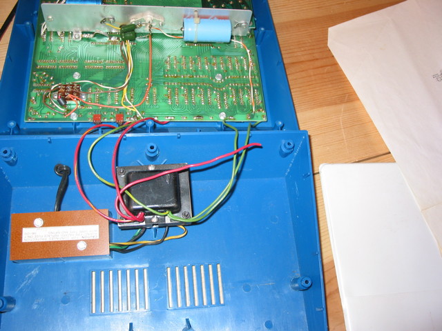 A Heathkit ET-3400 opened up, exposing the transformer and the underside of the circuit board. One of the wires from the transformer clearly does not connect to where it's supposed to be soldered to the circuit board.