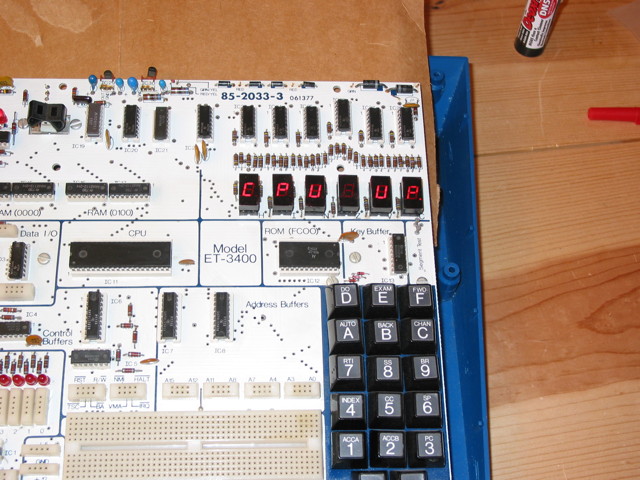A Heathkit ET-3400 microprocessor trainer with its top case removed.  The unit is on and the 6 seven-segment LED displays show CPU UP