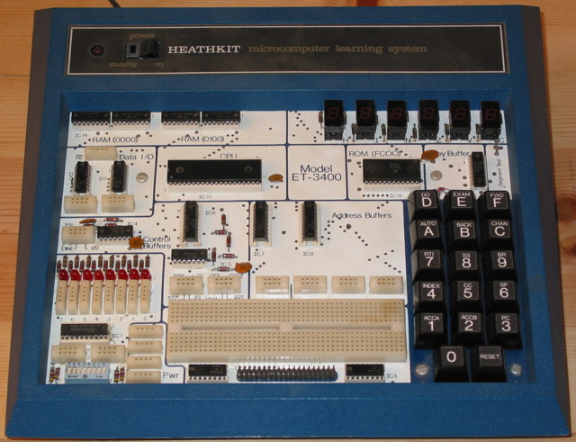 Heathkit ET-3400 Microprocessor trainer is a single board computer with a hex keypad, 6 seven-segment LED displays, on the board are several solder-less connection points and an empty solderless protoblock.  Silkscreen on the board is: Model ET-3400