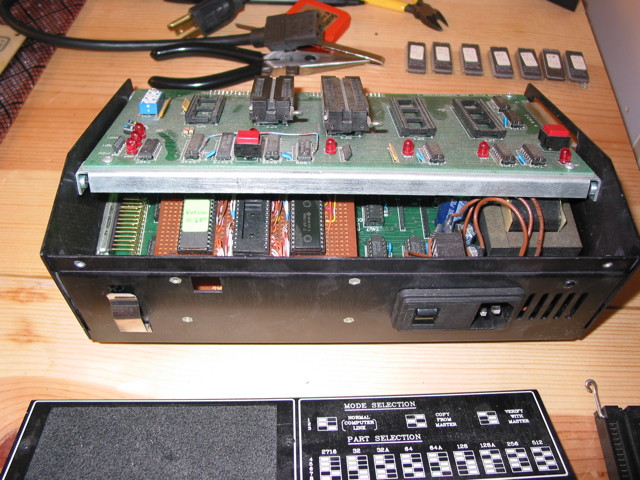 A view of the inside of an EPROM programmer where there's clearly a homebrew daughter card piggybacking somehow inside.