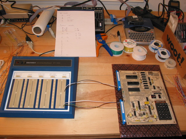 A KIM-1 on a workbench connected to a breadboard with a few wires.