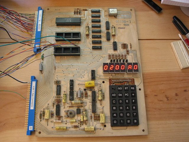 A KIM-1 with wires going off to the side.  The KIM-1 has 6 bright seven-segment LED displays that are showing 0200 A0