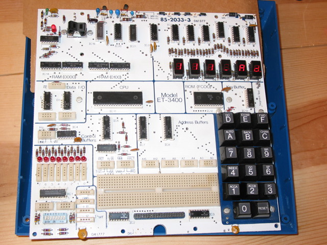 A Heathkit ET-3400 microprocessor trainer with its top case removed.  The unit is on and the 6 seven-segment LED displays show 111_Ad