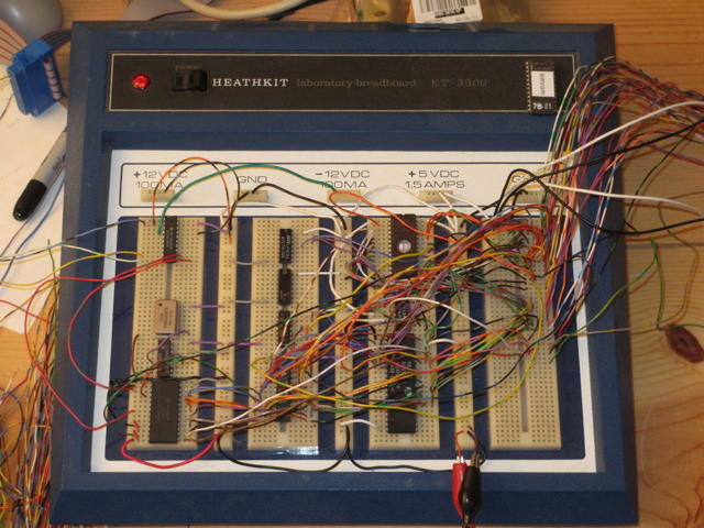 A Heathkit Breadboard unit with some circuitry on it.  Clearly identifiable is an EPROM, some static RAM, and a UART with a crystal oscillator.